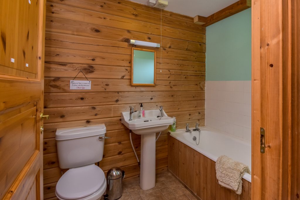 Downstairs bathroom with basin, toilet and bath.