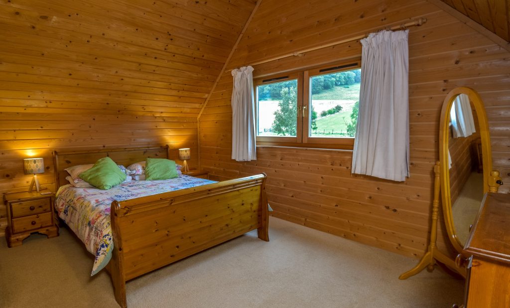 Self Catering Holiday Accommodation - Upstairs room with king size bed, wardrobe, bed side tables, chest of drawers, full length mirror and hairdryer.